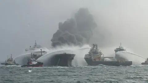 Fires still burning and one missing after tanker collision